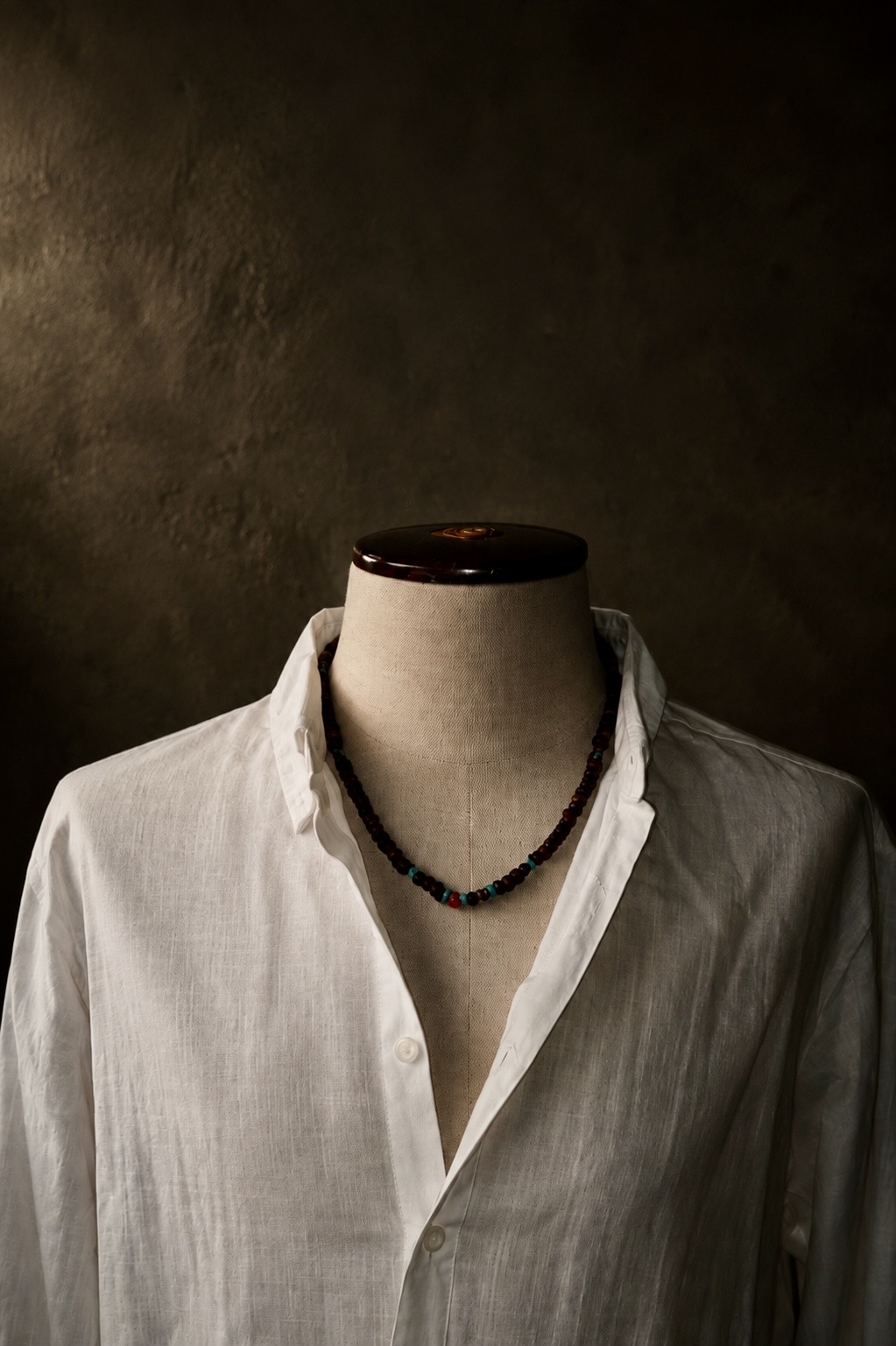 Capri necklace worn with a white linen shirt
